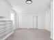 Bright bedroom boasts light wood floors, built-in shelving, and sliding closet doors at 1912 Glenridge Dr, Indianapolis, IN 46218