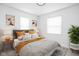 Comfortable bedroom with neutral tones, stylish decor, and two windows for natural light at 1912 Glenridge Dr, Indianapolis, IN 46218