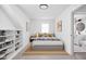 Comfortable bedroom with sloped ceilings, shelving, and bathroom access at 1912 Glenridge Dr, Indianapolis, IN 46218