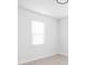A bright and airy bedroom featuring light wood floors and white walls with one window at 1912 Glenridge Dr, Indianapolis, IN 46218