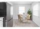 Cozy dining area features a round table and seating for four, adjacent to modern kitchen at 1912 Glenridge Dr, Indianapolis, IN 46218
