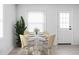 Charming dining area with round table, seating for four, and natural light from the window at 1912 Glenridge Dr, Indianapolis, IN 46218
