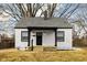 Charming home featuring a gray roof, black trim, and a cozy front porch perfect for relaxing at 1912 Glenridge Dr, Indianapolis, IN 46218
