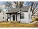 Beautiful home with a dark roof, black trim around the windows, and a black front door at 1912 Glenridge Dr, Indianapolis, IN 46218