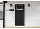 Close-up of a black front door, with secure code lock and white trim at 1912 Glenridge Dr, Indianapolis, IN 46218