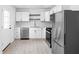 Modern kitchen with white cabinets, subway tile backsplash, and stainless steel appliances at 1912 Glenridge Dr, Indianapolis, IN 46218