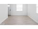 Bright living room with light wood floors and white walls; entrance on left and window on right at 1912 Glenridge Dr, Indianapolis, IN 46218