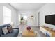 Bright living room with open floor plan to dining area, features neutral decor and ample natural light at 1912 Glenridge Dr, Indianapolis, IN 46218