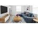 Cozy living room with a blue sectional sofa, stylish rug, and modern decor at 1912 Glenridge Dr, Indianapolis, IN 46218