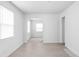 Bright living room with light wood floors and white walls with an entrance to a hallway at 1912 Glenridge Dr, Indianapolis, IN 46218