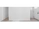 Well lit room featuring light wood floors and white walls with white door at 1912 Glenridge Dr, Indianapolis, IN 46218