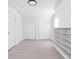 Bright room with white walls, light wood floors, two closets, and built-in shelving at 1912 Glenridge Dr, Indianapolis, IN 46218