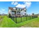 Expansive backyard featuring a wrought iron fence, lush lawn, and beautiful home exterior at 19795 Chatham Shore Ln, Westfield, IN 46074
