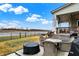 Inviting backyard patio area with waterfront views, complete with outdoor seating and a covered area at 19795 Chatham Shore Ln, Westfield, IN 46074
