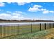 Scenic backyard view with wrought iron fencing enclosing the property overlooking a body of water at 19795 Chatham Shore Ln, Westfield, IN 46074