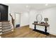 Finished basement with hardwood floors leading to staircase with bar height table to showcase decor at 19795 Chatham Shore Ln, Westfield, IN 46074