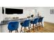Finished basement features a sleek bar with blue velvet chairs and a flat-screen TV for entertainment at 19795 Chatham Shore Ln, Westfield, IN 46074