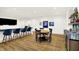The finished basement showcases a wet bar, round table, and wall-mounted television, perfect for relaxing at 19795 Chatham Shore Ln, Westfield, IN 46074