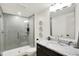 Modern bathroom features a tiled shower with glass door, a vanity with marble countertop, and decorative wall accents at 19795 Chatham Shore Ln, Westfield, IN 46074