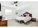 Cozy bedroom with dark wood accents and furnishings, a ceiling fan, and light neutral carpet at 19795 Chatham Shore Ln, Westfield, IN 46074