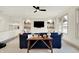Upstairs bonus room features built-in shelving, large windows, a ceiling fan, and seating area at 19795 Chatham Shore Ln, Westfield, IN 46074