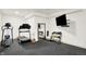 The exercise room features a mirrored wall and free weights for effective workouts at 19795 Chatham Shore Ln, Westfield, IN 46074