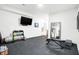 Bright exercise room with weight rack, fitness ball, rubber floor and large mirror for home workouts at 19795 Chatham Shore Ln, Westfield, IN 46074