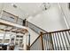 Open foyer featuring high ceilings, wood and black railing, and ample natural light at 19795 Chatham Shore Ln, Westfield, IN 46074