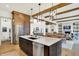 Open-concept kitchen with island seating, stainless steel appliances, and seamless flow to the dining area at 19795 Chatham Shore Ln, Westfield, IN 46074