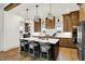 Bright kitchen with a central island, stylish pendant lighting, and modern wood cabinets at 19795 Chatham Shore Ln, Westfield, IN 46074