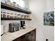 Butler's pantry featuring open shelving, modern appliances, and light countertops at 19795 Chatham Shore Ln, Westfield, IN 46074