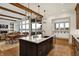 Spacious kitchen with granite countertops, island seating, and views of the living and dining area at 19795 Chatham Shore Ln, Westfield, IN 46074