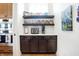 Butler's pantry featuring open shelving, modern appliances, light countertops, and wood floors at 19795 Chatham Shore Ln, Westfield, IN 46074