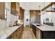 Modern kitchen with stone countertops, stainless steel appliances, and dark wood cabinetry at 19795 Chatham Shore Ln, Westfield, IN 46074