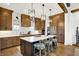 Well-lit kitchen featuring a large island, wood cabinets, and sleek countertops at 19795 Chatham Shore Ln, Westfield, IN 46074