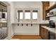 Kitchen pass-through window to the deck and cabinets with a beverage cooler at 19795 Chatham Shore Ln, Westfield, IN 46074
