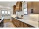 Gourmet kitchen with bright countertops, wooden cabinets, and a cooktop at 19795 Chatham Shore Ln, Westfield, IN 46074
