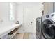 Bright laundry room featuring light countertops, stainless steel washer and dryer, and built-in sink at 19795 Chatham Shore Ln, Westfield, IN 46074