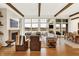 Elegant living room with a fireplace, hardwood floors, and large windows offering scenic views at 19795 Chatham Shore Ln, Westfield, IN 46074