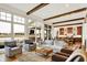 Open-concept living room connecting to the kitchen, featuring hardwood floors and large windows for ample light at 19795 Chatham Shore Ln, Westfield, IN 46074