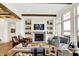 Comfortable living room with fireplace, built-in shelving, and large windows showcasing natural light at 19795 Chatham Shore Ln, Westfield, IN 46074