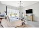 Bright main bedroom features a large window, a light-colored dresser, and carpeted floors at 19795 Chatham Shore Ln, Westfield, IN 46074