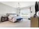 Spacious main bedroom featuring a decorative chandelier, a large window, and a comfortable bed at 19795 Chatham Shore Ln, Westfield, IN 46074