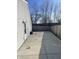 Spacious backyard featuring a large concrete patio area and wood fence at 2027 E Werges Ave, Indianapolis, IN 46237
