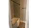 Tiled shower and tub area showcasing neutral tile and updated fixtures at 2027 E Werges Ave, Indianapolis, IN 46237