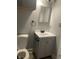 Cozy bathroom featuring a modern vanity with gray cabinets and a framed mirror at 2027 E Werges Ave, Indianapolis, IN 46237