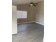 Bright bedroom with wood-look tile flooring, a ceiling fan, and a window with blinds at 2027 E Werges Ave, Indianapolis, IN 46237