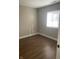 Bedroom with hardwood flooring, white trim, and window with blinds at 2027 E Werges Ave, Indianapolis, IN 46237