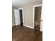 Bedroom with hardwood floors, neutral walls, and multiple doorways at 2027 E Werges Ave, Indianapolis, IN 46237