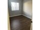 Bedroom with hardwood flooring, white trim, and window with blinds at 2027 E Werges Ave, Indianapolis, IN 46237